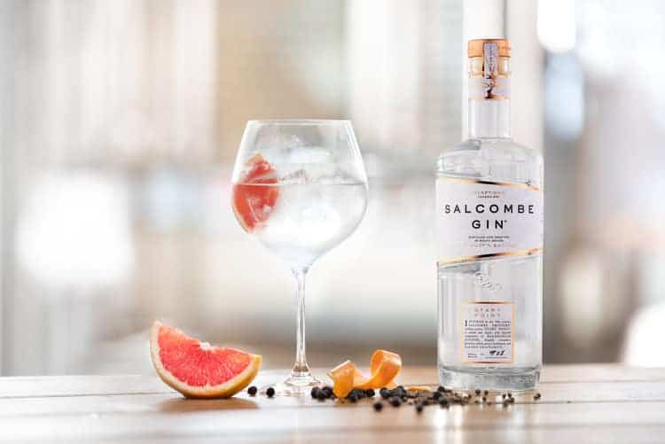 A bottle of Salcombe Gin with a glass and some fruit. - Wessex Commercial Solutions Xero Accountants in Exeter and Yeovil